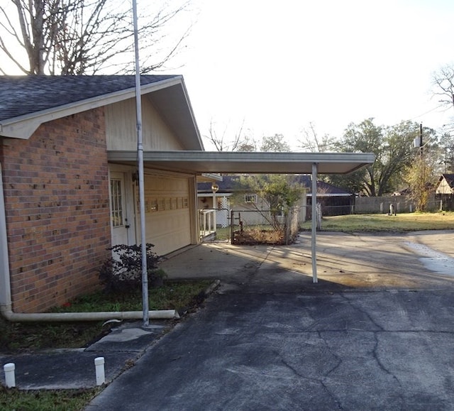 view of side of home with a carport