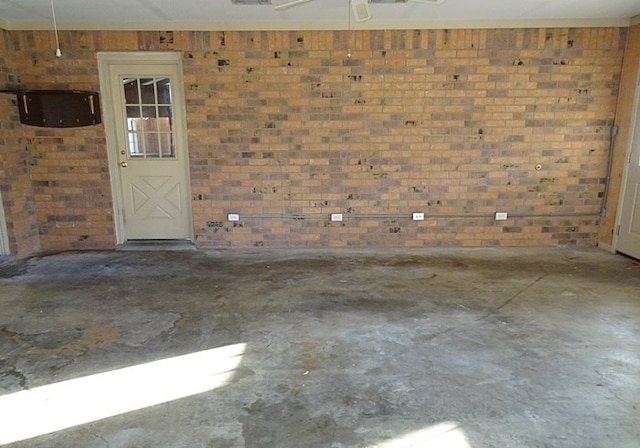 interior space with wooden walls, concrete floors, and brick wall