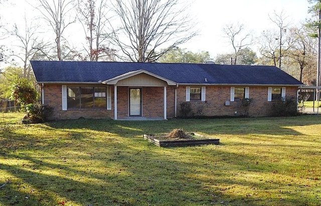 rear view of property with a lawn