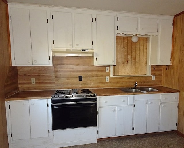 kitchen with electric stove, decorative backsplash, sink, and white cabinets