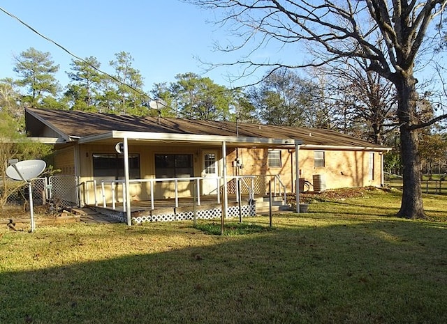 rear view of house featuring a lawn