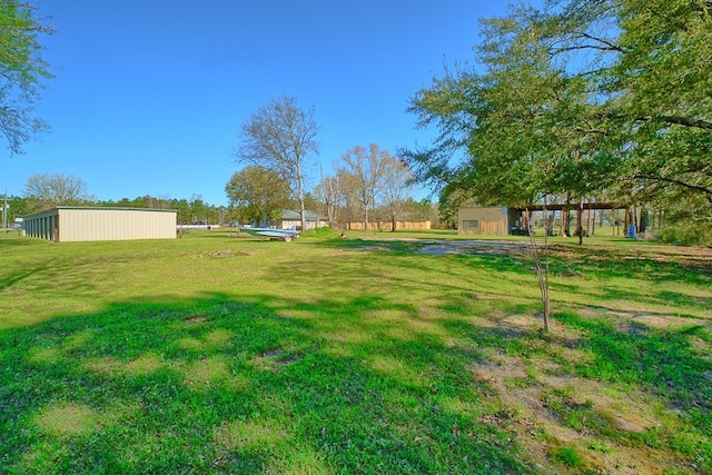 view of yard with an outbuilding and a pole building