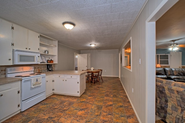 kitchen featuring white appliances, white cabinets, a peninsula, and open shelves
