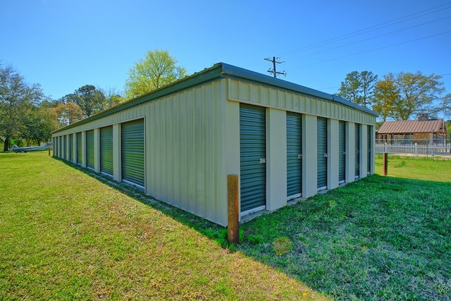 view of outdoor structure with an outbuilding and fence