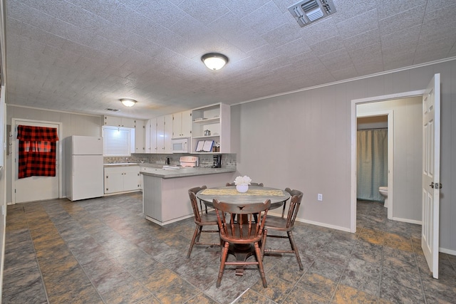 dining room featuring visible vents, baseboards, and stone finish floor