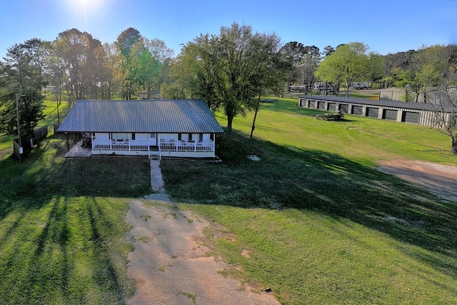 exterior space with a garage, driveway, and a yard