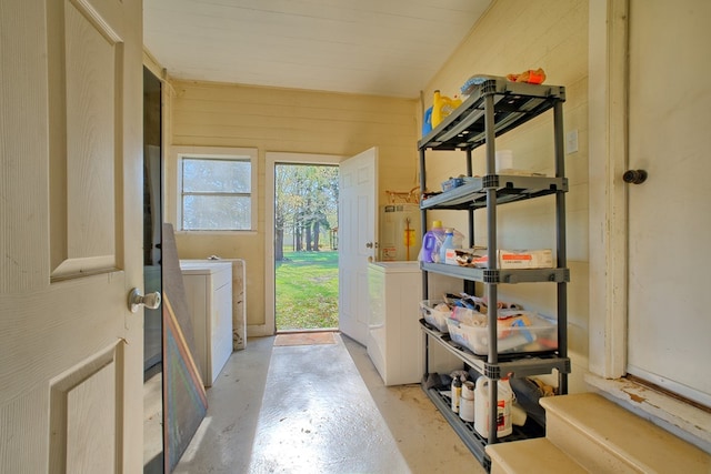 storage area with gas water heater and independent washer and dryer