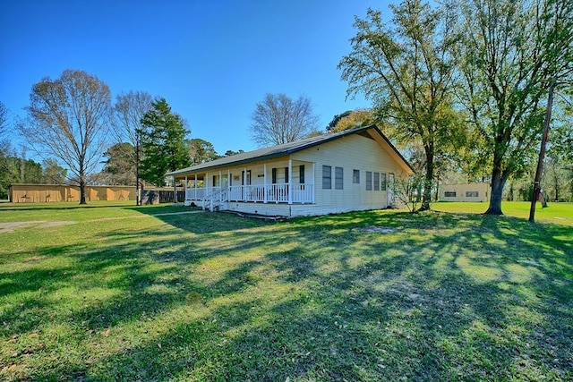 view of property exterior with a lawn and a porch
