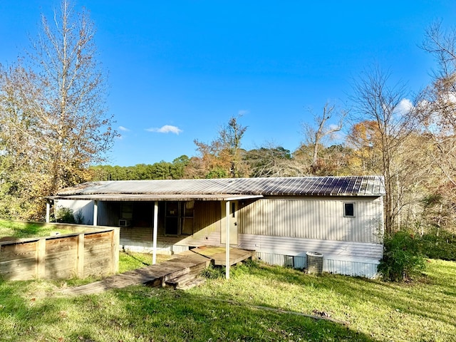 230 Dogwood Ests, Hemphill, TX 75948 - rear view of property with an outbuilding, an exterior structure, and metal roof