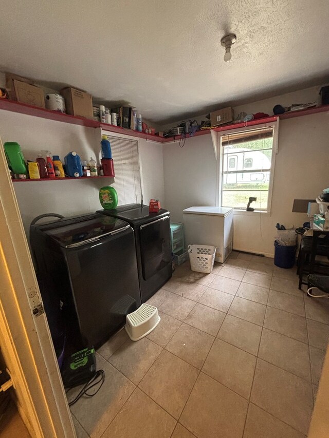 11774 US Highway 69 S, Huntington, TX 75949 - laundry room featuring washing machine and dryer, light tile patterned flooring, and a textured ceiling