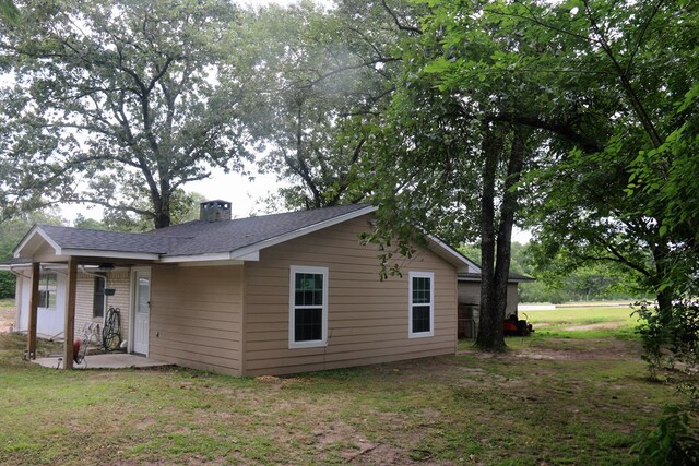 11774 US Highway 69 S, Huntington, TX 75949 - back of house featuring a chimney, a lawn, and roof with shingles
