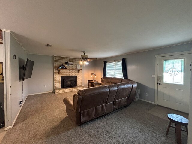 11774 US Highway 69 S, Huntington, TX 75949 - living room with a ceiling fan, a fireplace, carpet flooring, baseboards, and crown molding