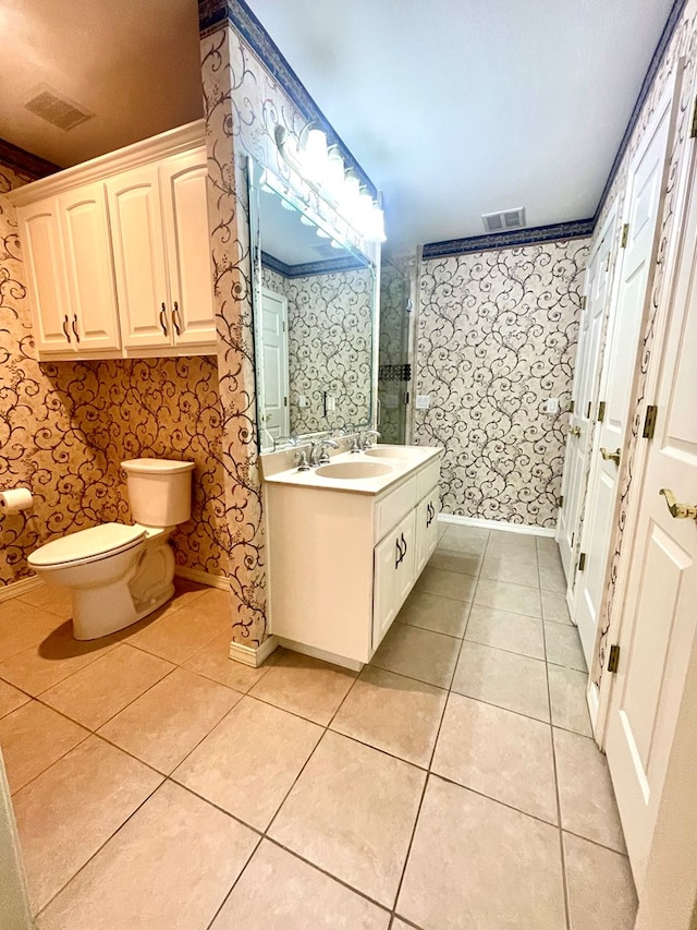 bathroom featuring tile patterned flooring, vanity, and toilet