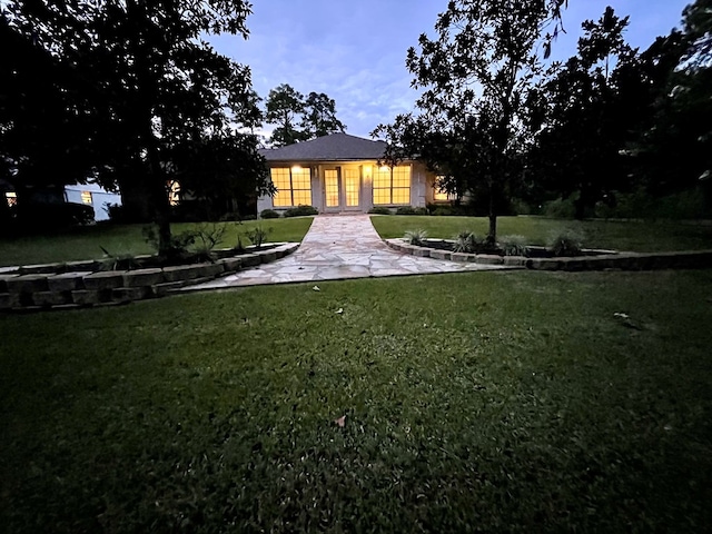 exterior space with a yard and french doors