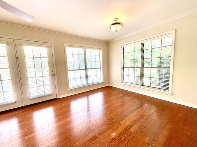 entryway with ornamental molding and wood-type flooring