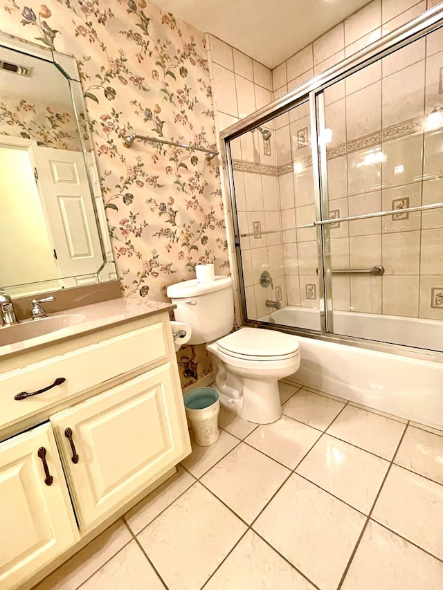 full bathroom with toilet, tile patterned floors, vanity, and shower / bath combination with glass door