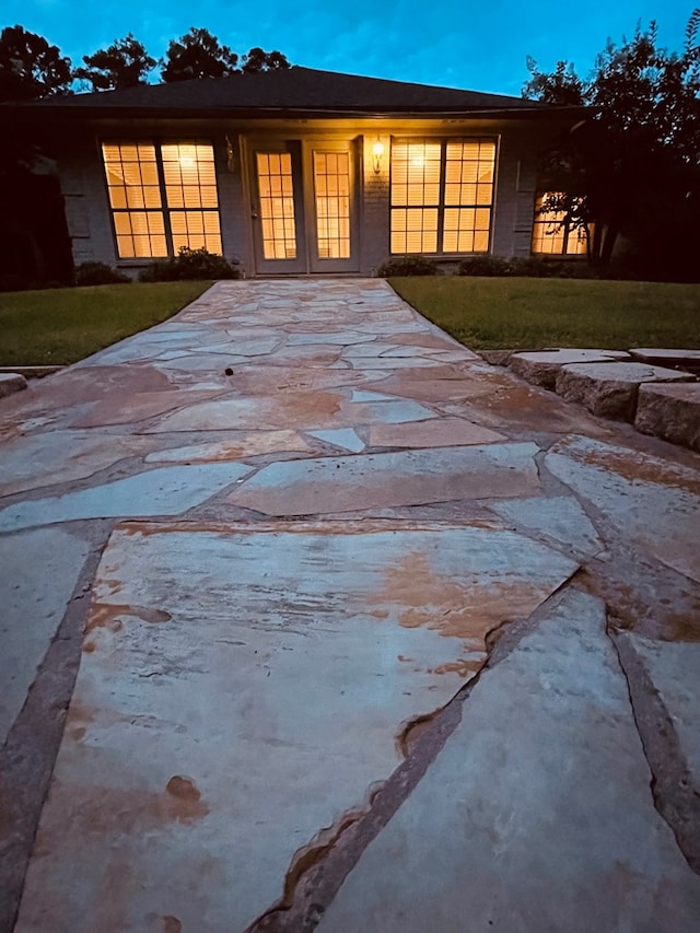 view of front facade featuring french doors and a front lawn