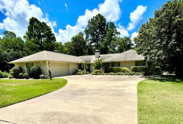 ranch-style home with a garage and a front lawn