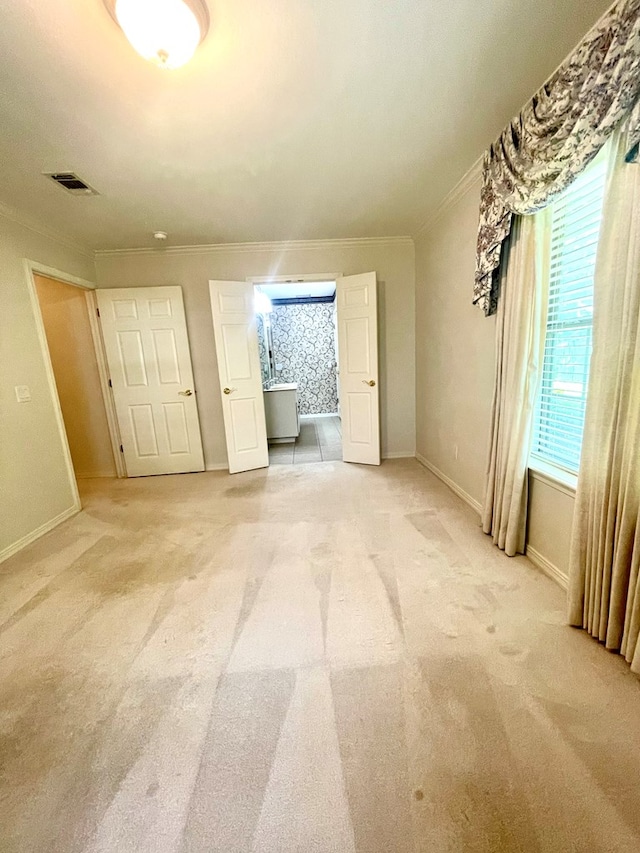 unfurnished bedroom featuring crown molding and carpet flooring