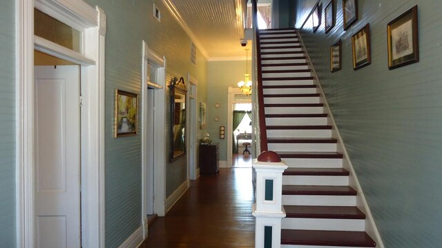 110 Market St, Hemphill, TX 75948 - stairway with visible vents, ornamental molding, wood finished floors, baseboards, and a chandelier