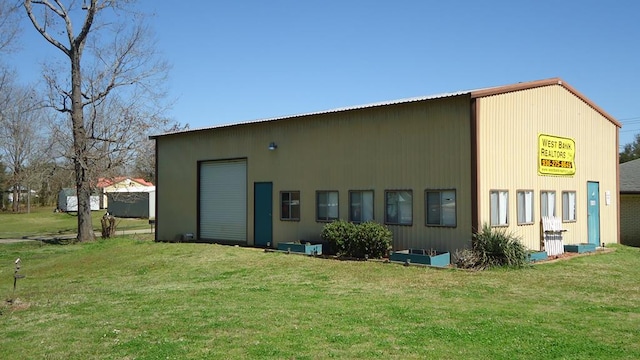 110 Market St, Hemphill, TX 75948 - rear view of house with a yard and a garage
