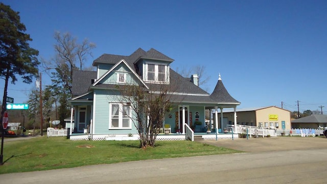 110 Market St, Hemphill, TX 75948 - victorian home with a front lawn and covered porch