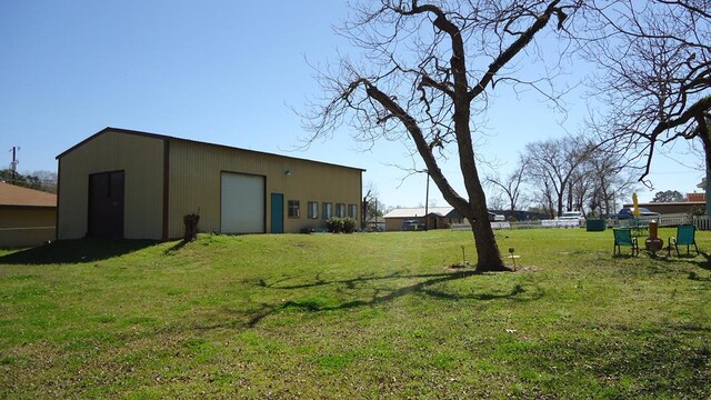 110 Market St, Hemphill, TX 75948 - view of yard featuring an outdoor structure, a garage, and a pole building