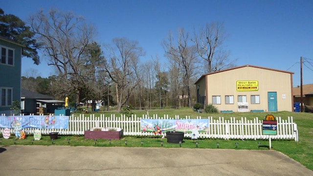 110 Market St, Hemphill, TX 75948 - view of swimming pool featuring a lawn and fence