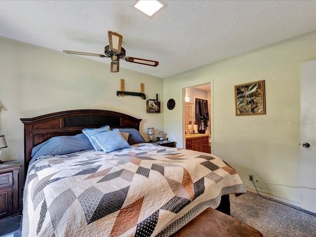 bedroom featuring carpet, ceiling fan, a textured ceiling, and ensuite bath