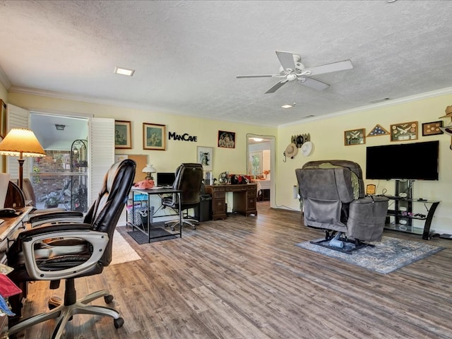 home office featuring wood-type flooring, a textured ceiling, ceiling fan, and ornamental molding