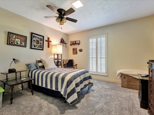 carpeted bedroom with a textured ceiling and ceiling fan