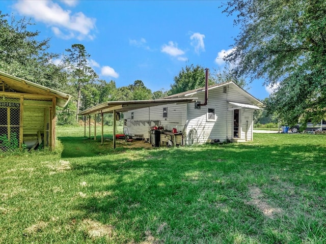 rear view of house featuring a yard