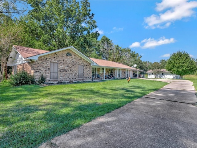 ranch-style house with a front yard and a porch