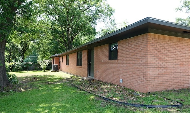 1009 Mockingbird Ln, Nacogdoches, TX 75964 - view of home's exterior featuring a lawn and brick siding