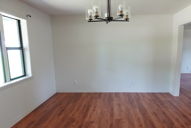 1009 Mockingbird Ln, Nacogdoches, TX 75964 - unfurnished dining area featuring a chandelier and wood finished floors
