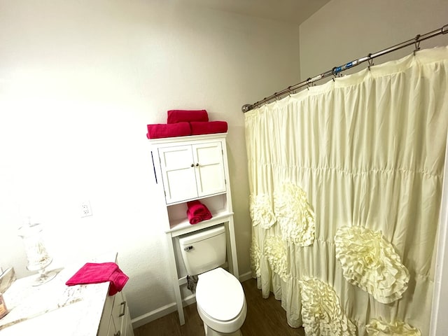 bathroom featuring vanity, hardwood / wood-style floors, toilet, and a shower with shower curtain