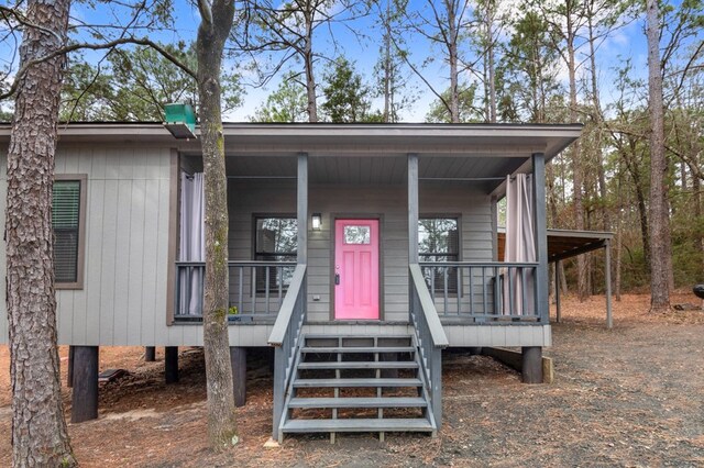 view of front of home with a carport and covered porch