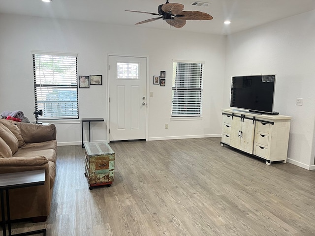 living room with hardwood / wood-style floors and ceiling fan