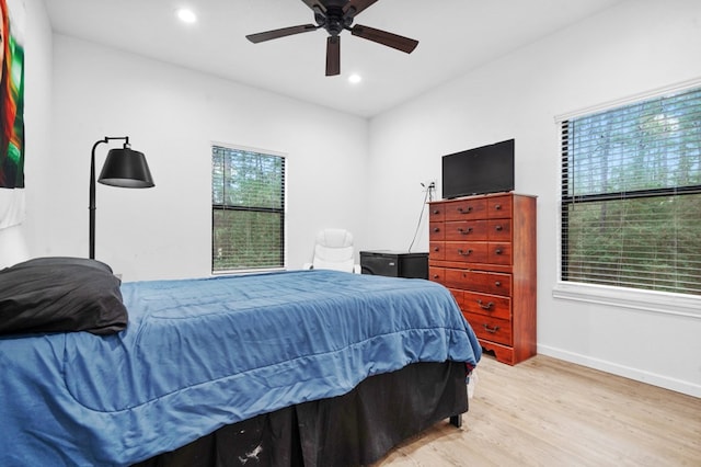 bedroom with ceiling fan, recessed lighting, light wood-style flooring, and baseboards