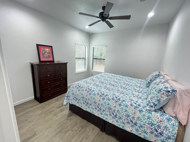 bedroom with ceiling fan and light wood-type flooring