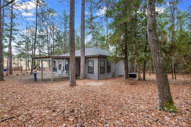 rear view of house with central air condition unit