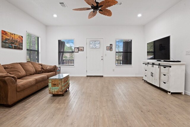 living room with dark wood-type flooring and ceiling fan