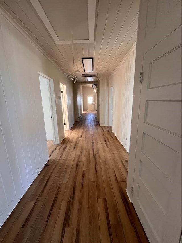 hall featuring hardwood / wood-style flooring and attic access