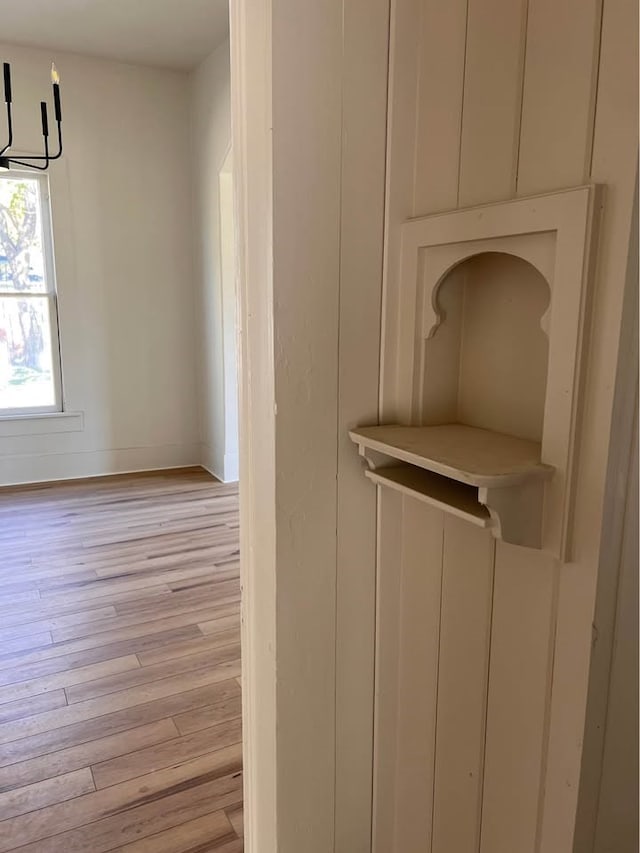 room details featuring baseboards and wood finished floors