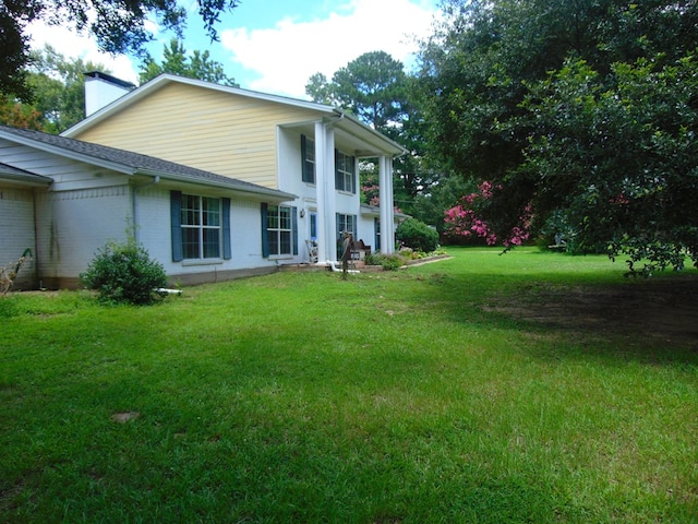 3198 Old Union Rd, Lufkin, TX 75904 - rear view of property with a chimney, a yard, and brick siding