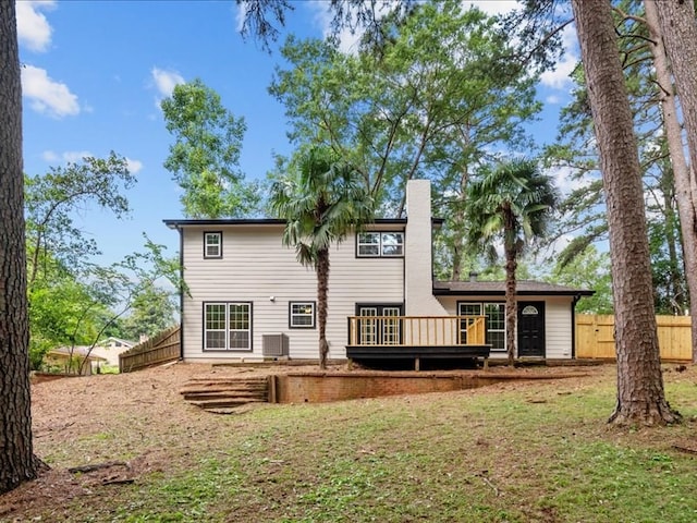 3202 Chimney Rock Ln, Nacogdoches, TX 75965 - rear view of house with a wooden deck and a chimney