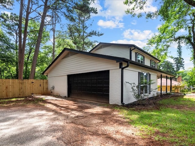 3202 Chimney Rock Ln, Nacogdoches, TX 75965 - view of side of home with driveway, brick siding, and an attached garage