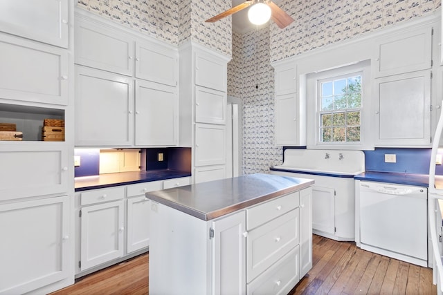 kitchen with white cabinetry, a center island, white dishwasher, and light wood-type flooring