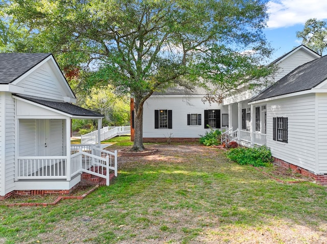 view of yard featuring covered porch