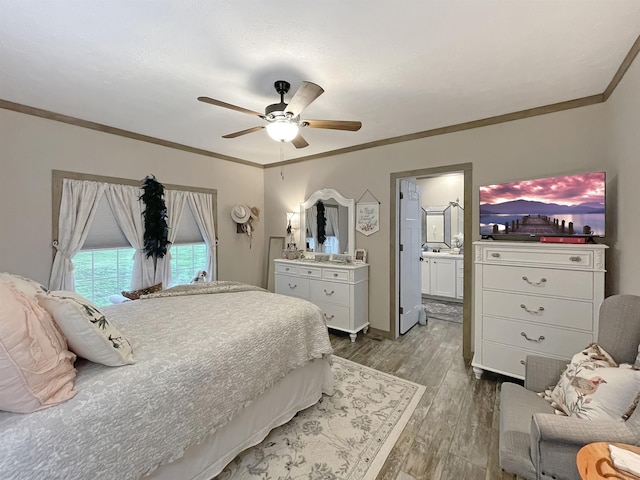 bedroom with crown molding, dark hardwood / wood-style floors, ceiling fan, and ensuite bath